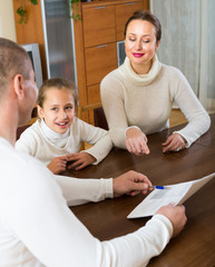 Father and daughter complete a questionnaire