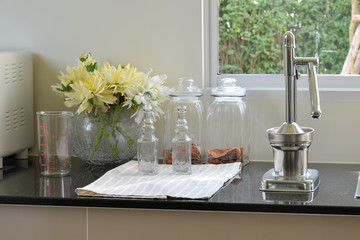 modern kitchenware and utensils on the black granite counter top