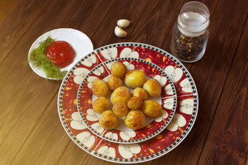Baked potatoes on plate on wooden table