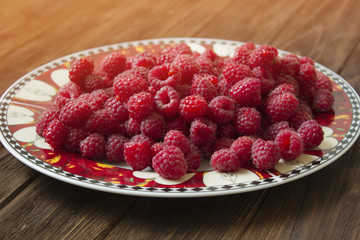 Sweet raspberries on plate