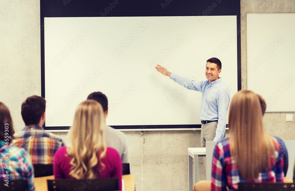 Wall mural group of students and smiling teacher in classroom