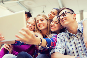 group of smiling students with tablet pc