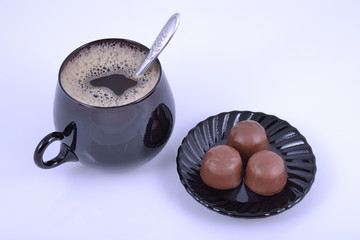 coffee at cup and chocolate at saucer