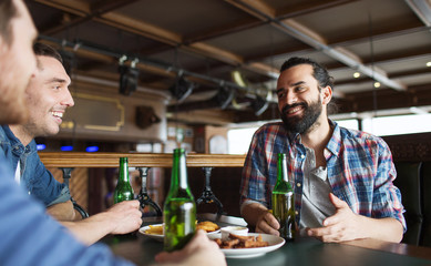 happy male friends drinking beer at bar or pub