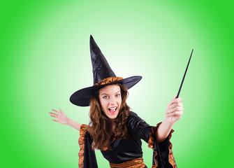 Witch with wand against the gradient 