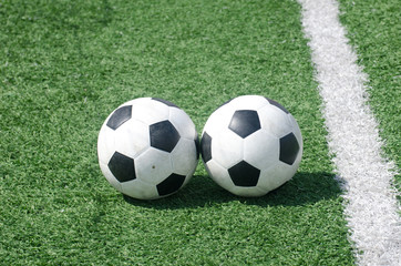 Fototapeta na wymiar footballs soccer on green grass field