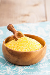 Dry raw cornmeal in wooden bowl