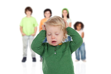 Blond baby worried with his brothers of background