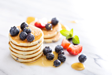 Stack of small pancakes with berries