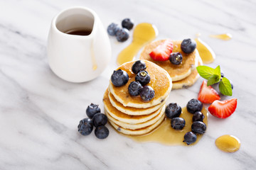 Stack of small pancakes with berries