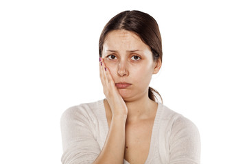 young woman without make-up has a toothache