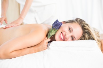 Obraz na płótnie Canvas Beautiful blonde lying on massage table with lavanda