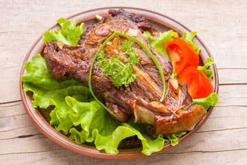 Roasted lamb ribs with rosemary and garlic on ceramic plate