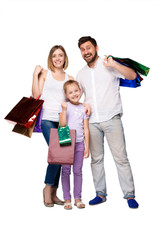 Happy family with shopping bags standing at studio 