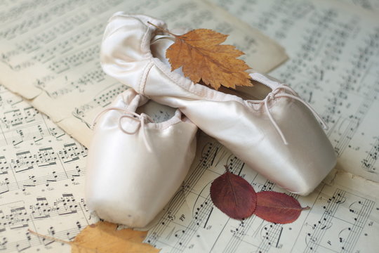Pointe shoes on musical notes