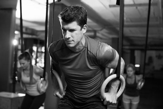Black And White Shot Of Man Exercising With Gymnastic Rings
