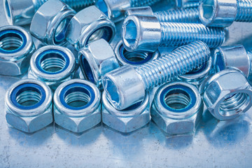 Close up view of threaded construction nuts and screw bolts on m