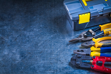 Copy space image of toolbox bolt cutter pliers and tin snips on 