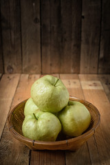 guava in basket on wood table