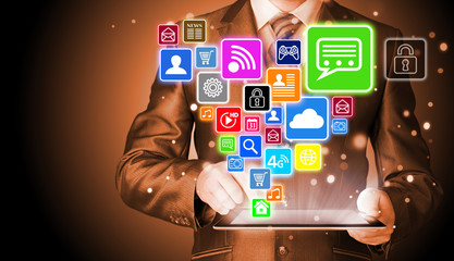 Business man using tablet PC with social media icon set