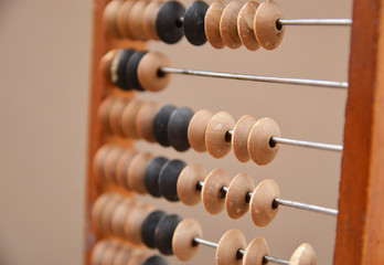 Old wooden abacus on gray background