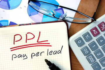 Notepad with Pay per lead PPL on office wooden table.