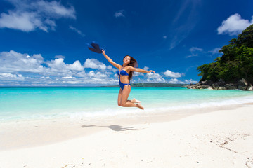 Fototapeta na wymiar Beautiful woman jumping on beach
