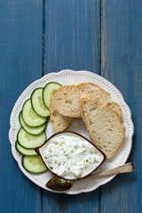cucumber dip with bread on plate