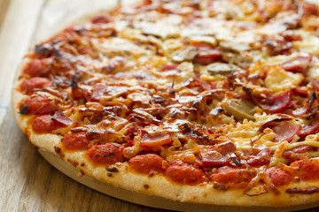 pizza on brown wooden background