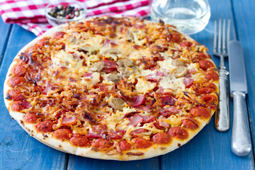 pizza with wine on blue wooden background