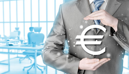 businessman protecting euro symbol