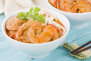 Thai Prawn Curry with Noodles - Thai red curry with prawns served with rice noodles in a white bowl.