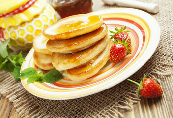 Homemade pancake with honey and strawberry