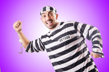 Convict criminal in striped uniform