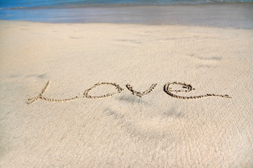 Fototapeta na wymiar Sign Love on sand