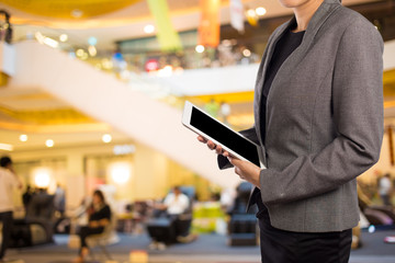 Businesswoman using digital tablet in the shopping mall.