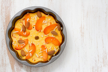 cake with almond and fruits in dish on white background