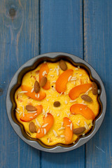 cake with almond and fruits in dish on blue background