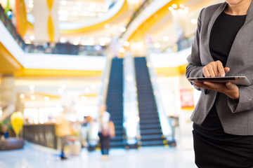 Businesswoman using digital tablet in the shopping mall.
