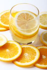 drink and stack of citrus fruits slices. Oranges and lemons.