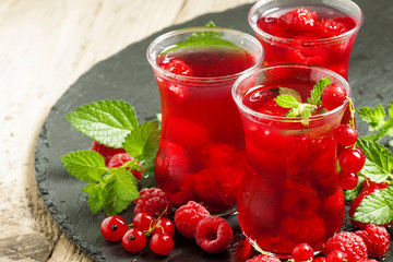 Red drink of raspberry and red currant and mint, selective focus