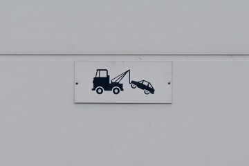 Tow truck sign on garage door