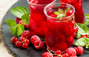 Red drink of raspberry and red currant and mint, selective focus