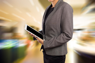 Businesswoman using digital tablet in the shopping mall.