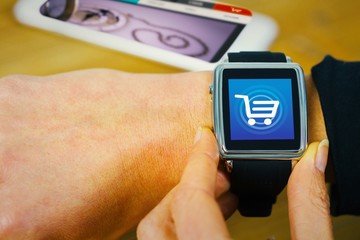 Composite image of businesswoman with smart watch on wrist