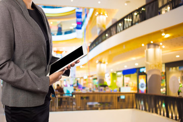 Businesswoman using digital tablet in the shopping mall.