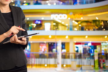 Businesswoman using digital tablet in the shopping mall.