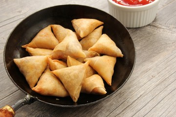 Samosas - Popular Indian deep fried snack with potato filling and covered with crispy crust