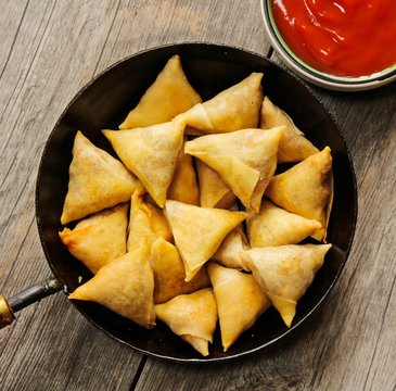 Samosas - Popular Indian deep fried snack with potato filling and covered with crispy crust