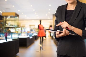Businesswoman using digital tablet in the shopping mall.